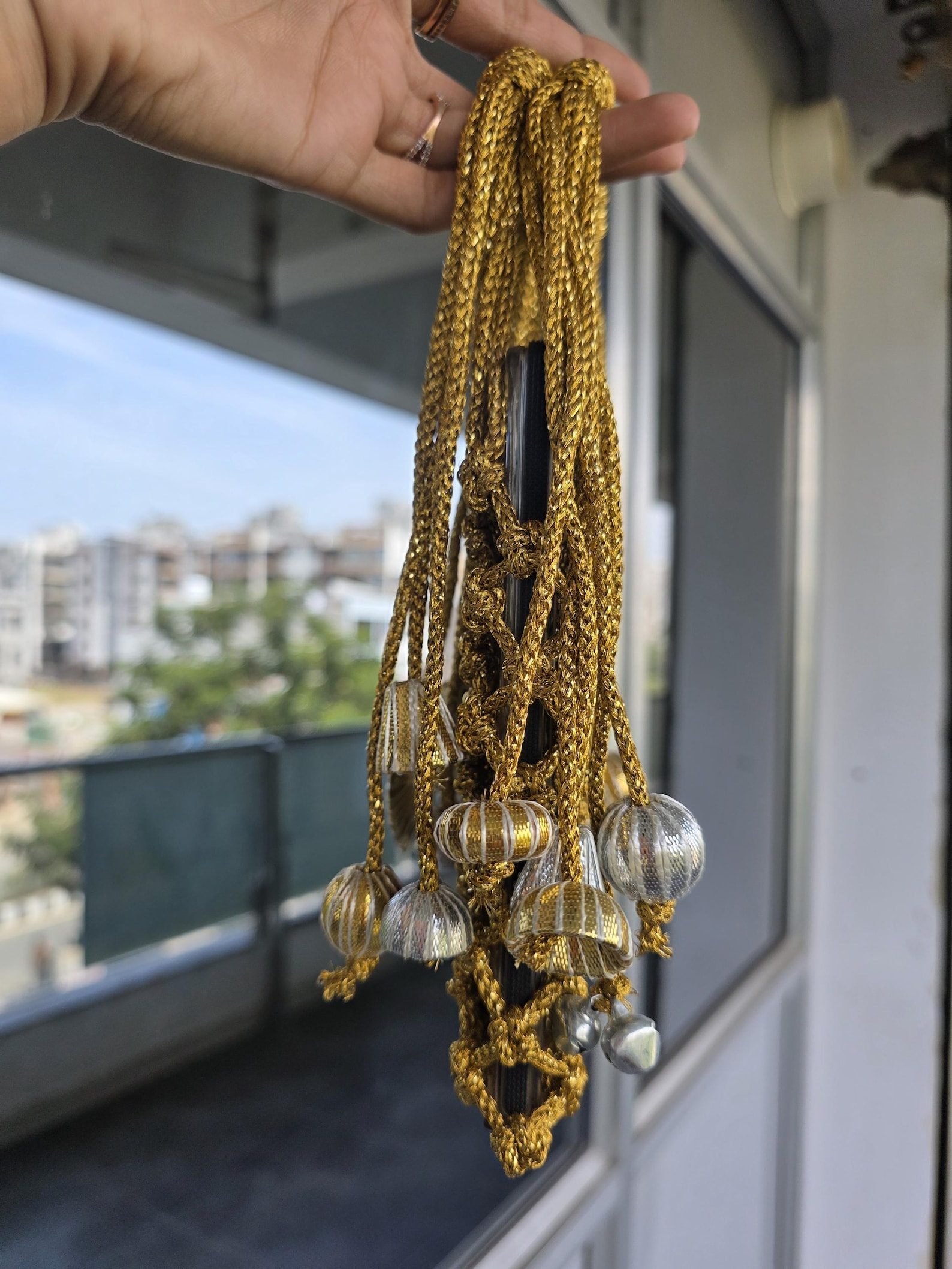 Golden Macrame Mobile Sling Bag with Shimmering Potli Tassels and Festive Zari Dori Work - bridal handbag