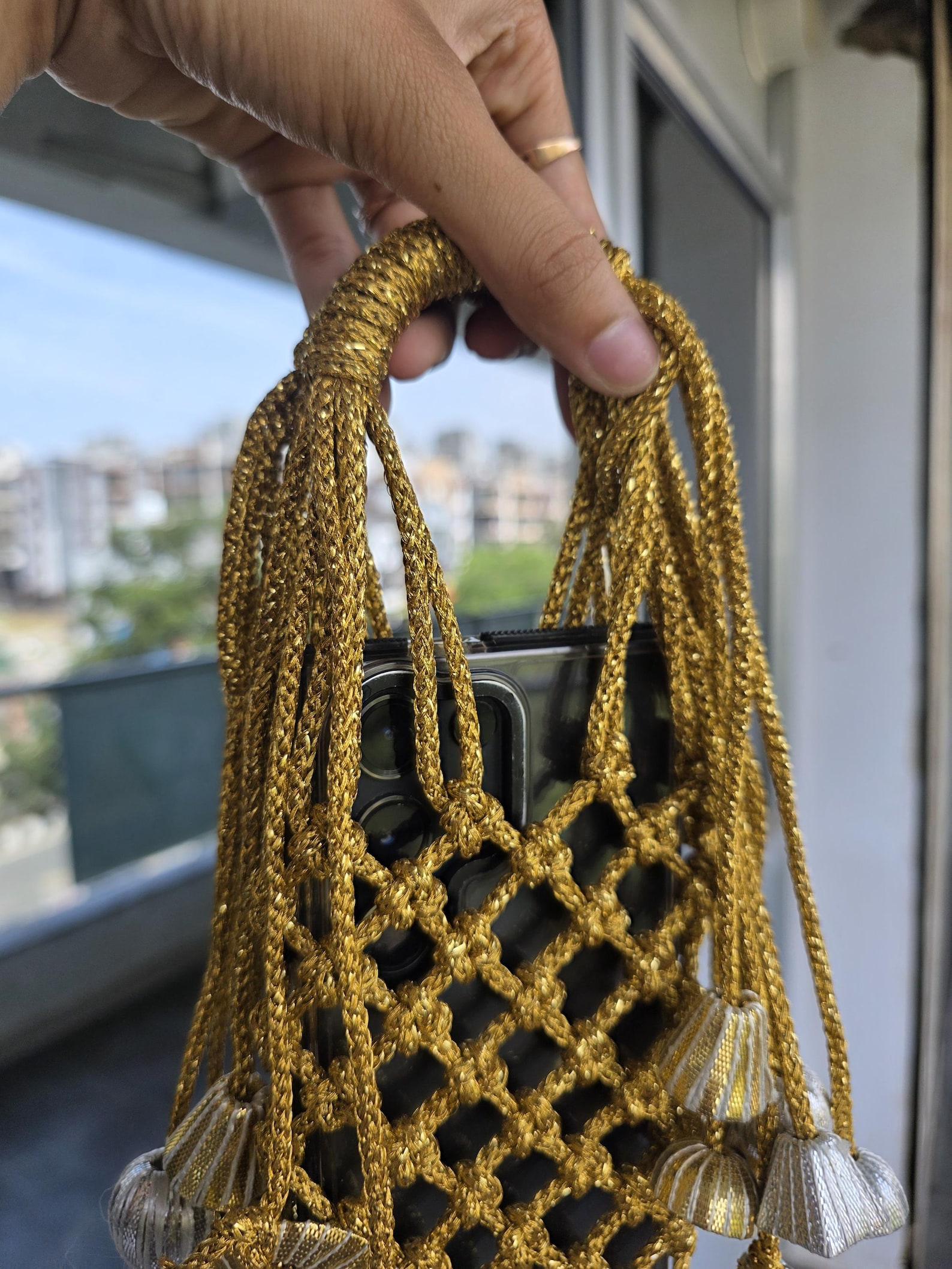 Golden Macrame Mobile Sling Bag with Shimmering Potli Tassels and Festive Zari Dori Work - bridal handbag