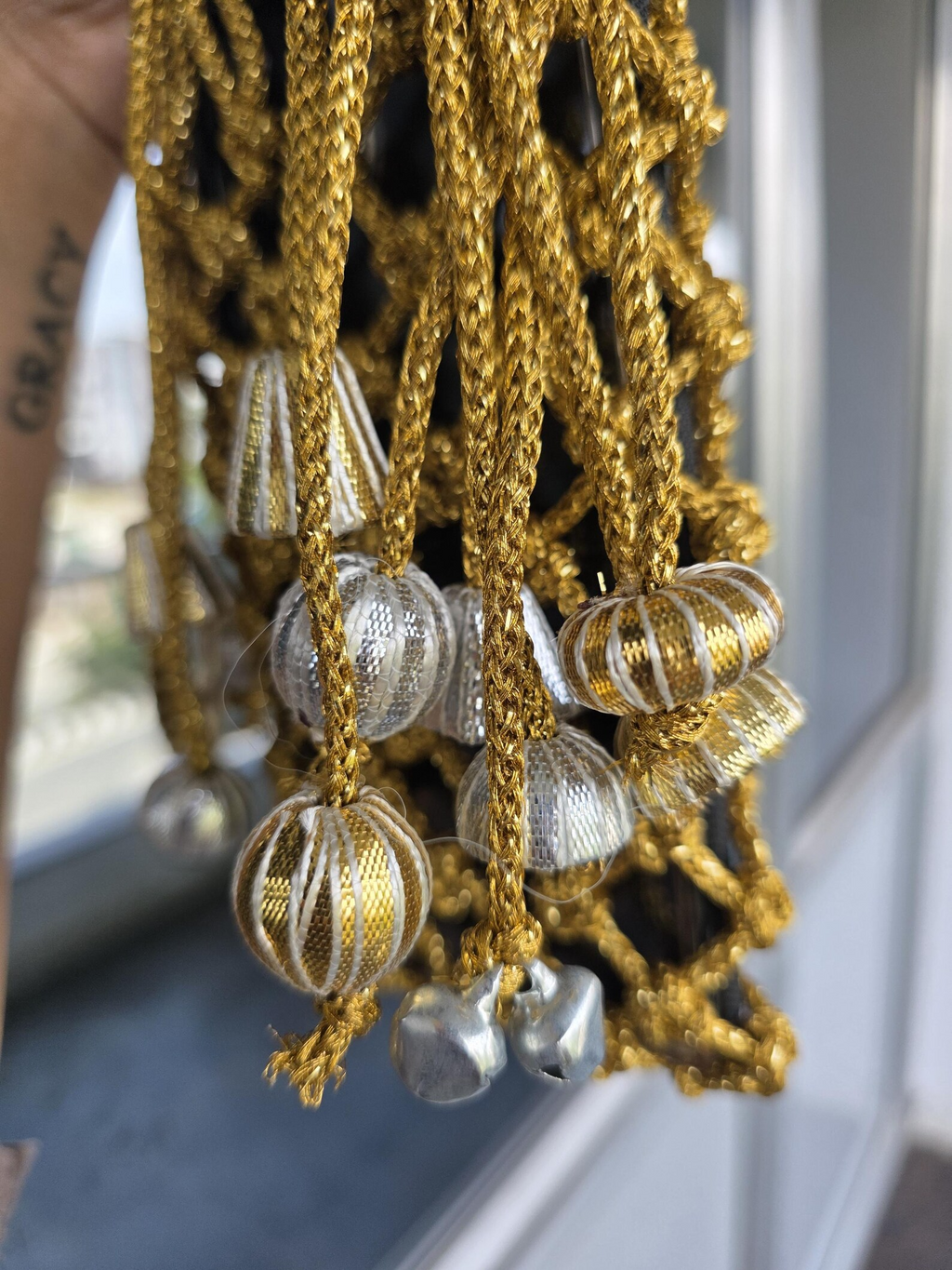 Golden Macrame Mobile Sling Bag with Shimmering Potli Tassels and Festive Zari Dori Work - bridal handbag