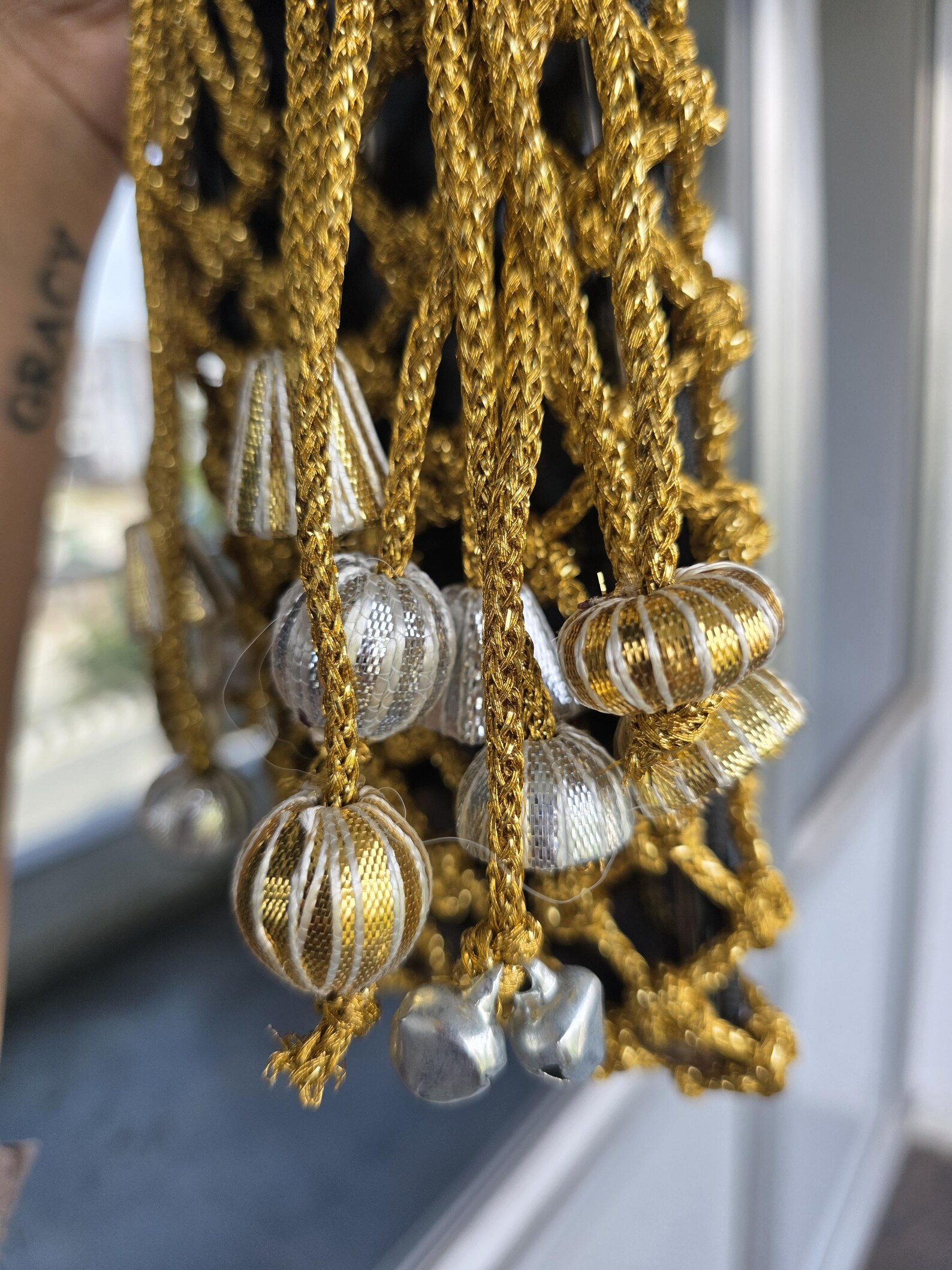 Golden Macrame Mobile Sling Bag with Shimmering Potli Tassels and Festive Zari Dori Work - bridal handbag