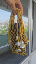 Golden Macrame Mobile Sling Bag with Shimmering Potli Tassels and Festive Zari Dori Work - bridal handbag